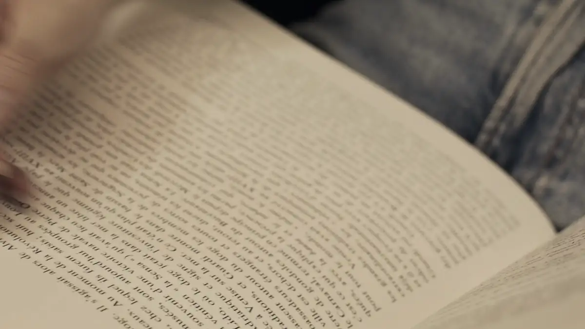 Hands turning the pages of a book