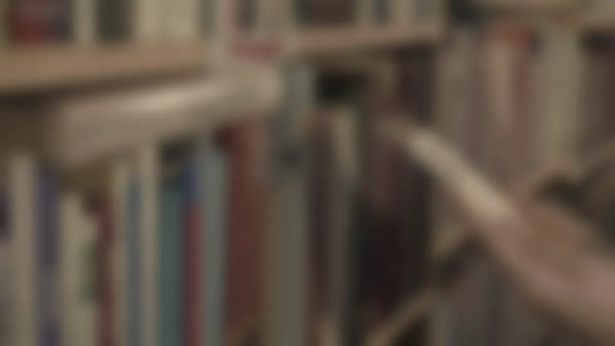 Bookshelves in a library, softly blurred