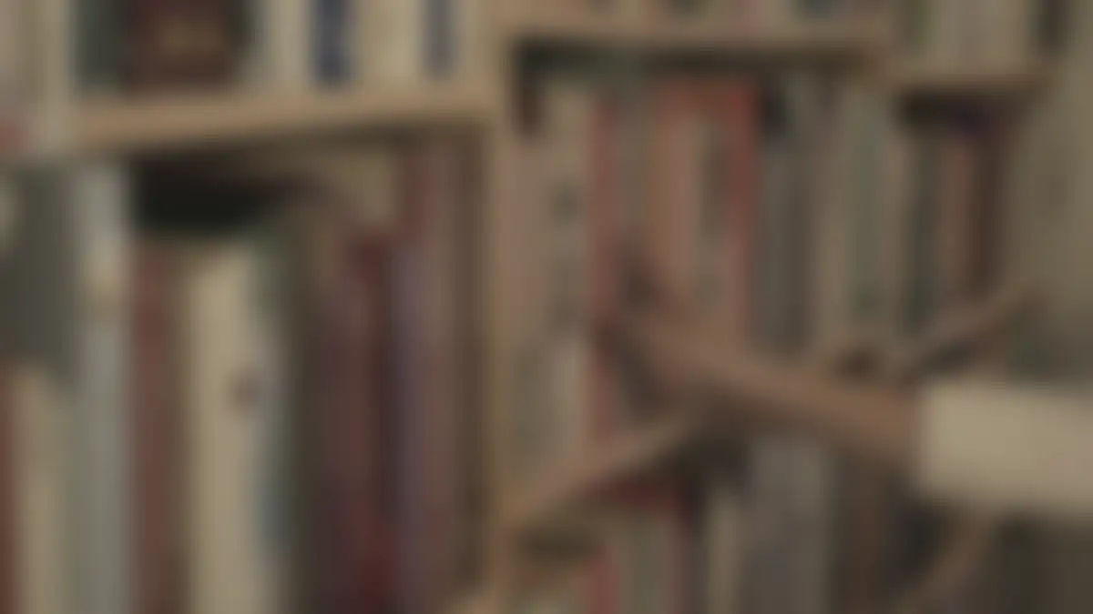Bookshelves in a library, softly blurred