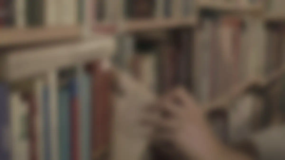 Bookshelves in a library, softly blurred