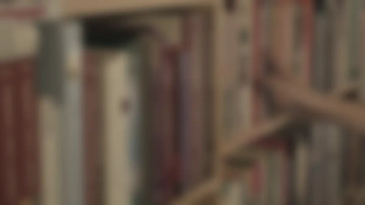 Bookshelves in a library, softly blurred
