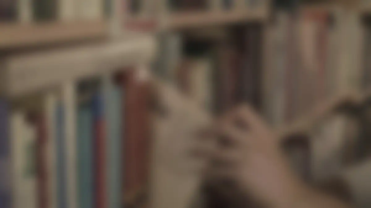 Bookshelves in a library, softly blurred