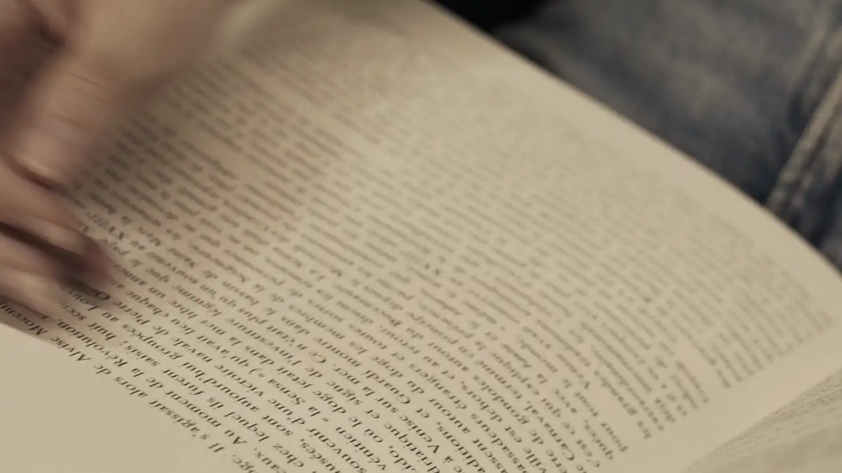 Hands turning the pages of a book