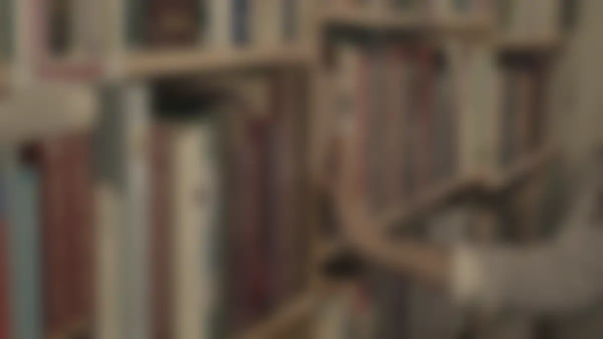 Bookshelves in a library, softly blurred