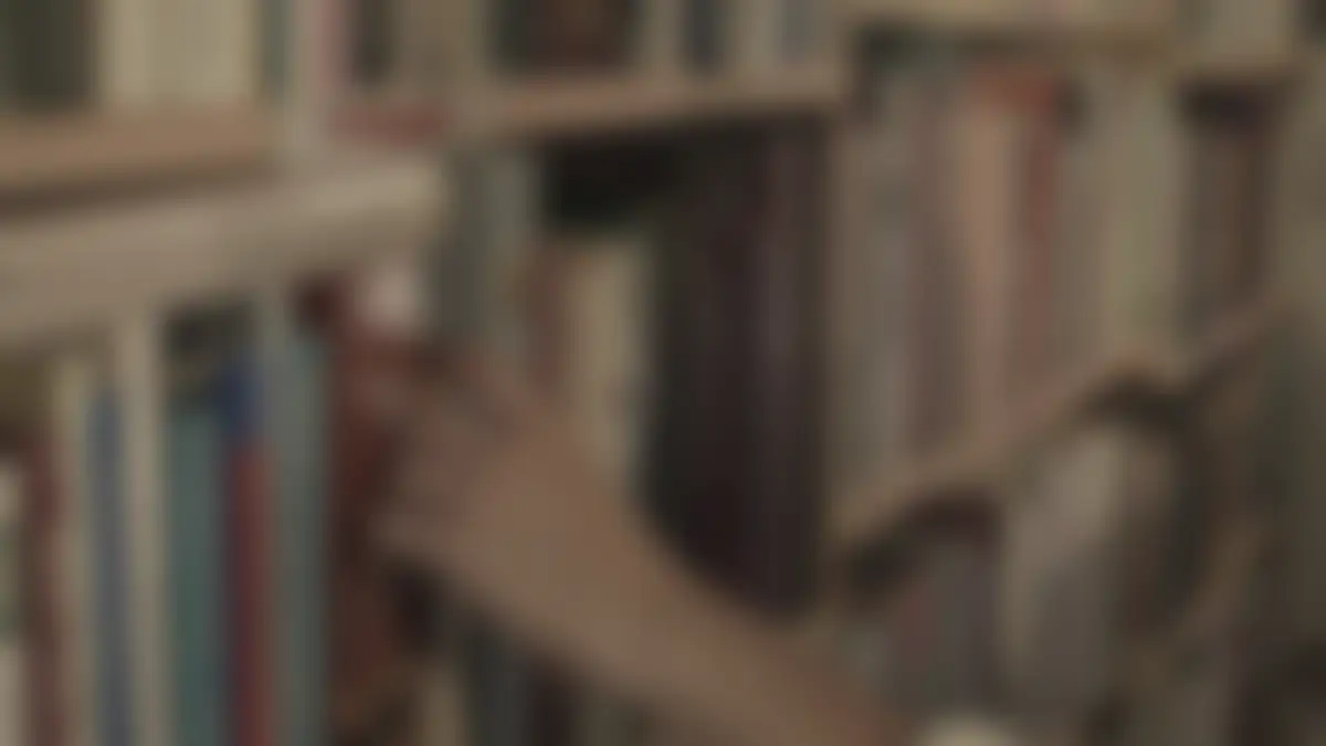Bookshelves in a library, softly blurred