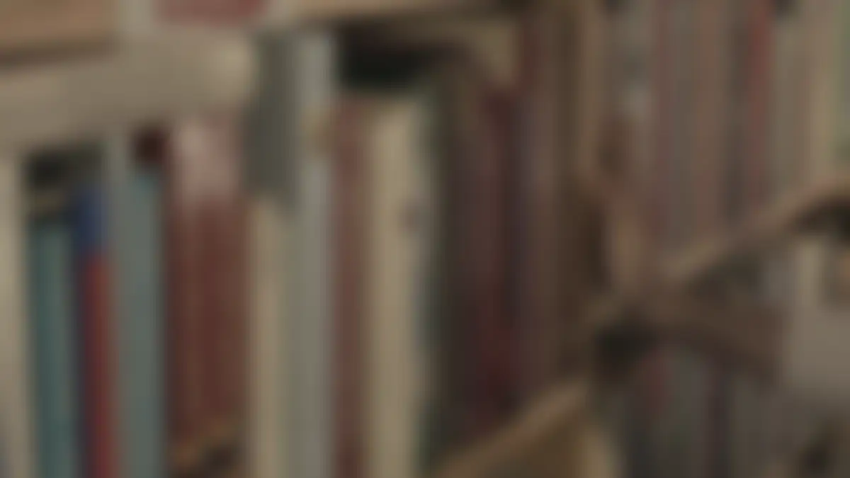 Bookshelves in a library, softly blurred