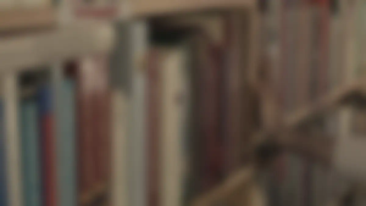 Bookshelves in a library, softly blurred