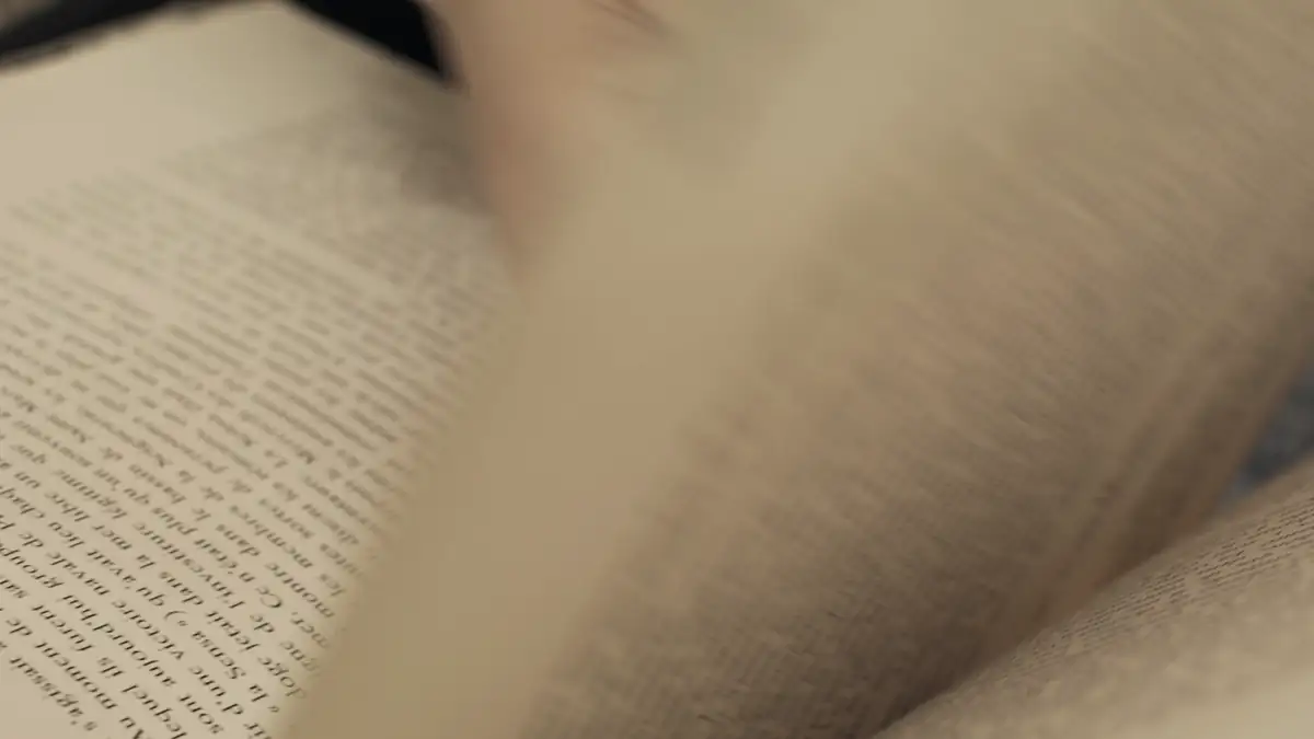Hands turning the pages of a book