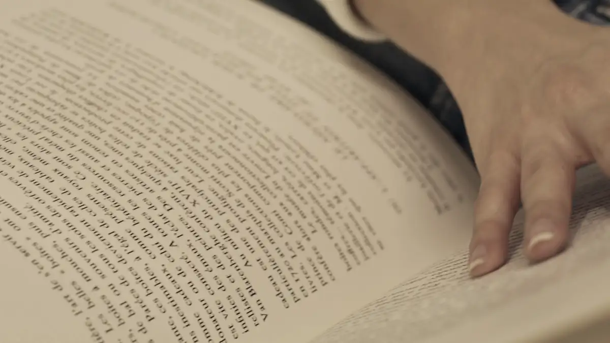 Hands turning the pages of a book