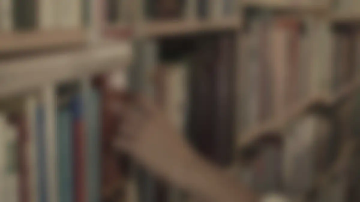 Bookshelves in a library, softly blurred