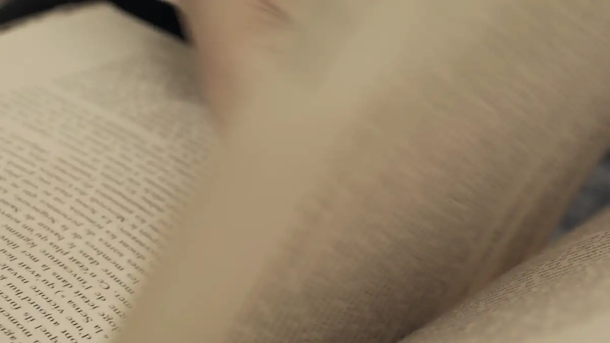 Hands turning the pages of a book