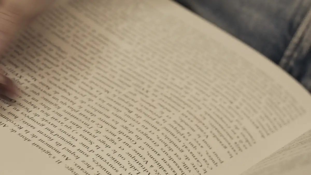 Hands turning the pages of a book