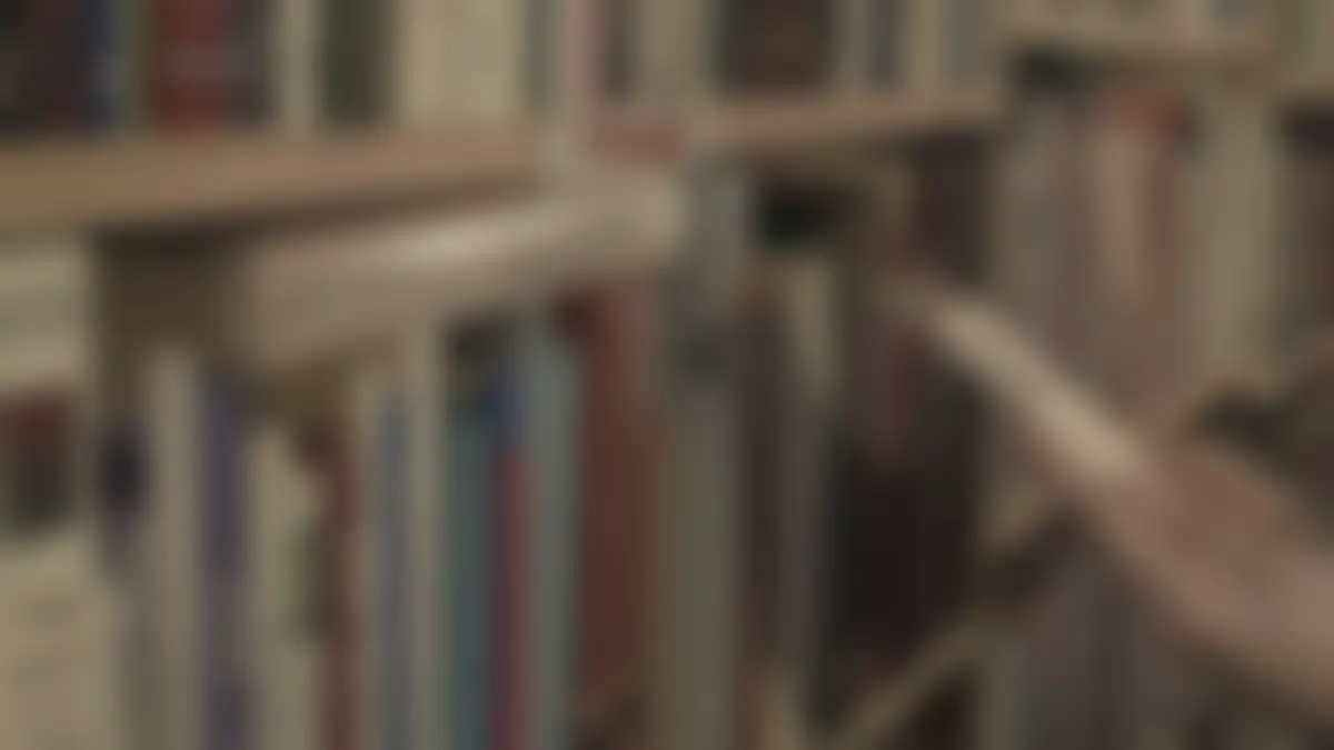 Bookshelves in a library, softly blurred