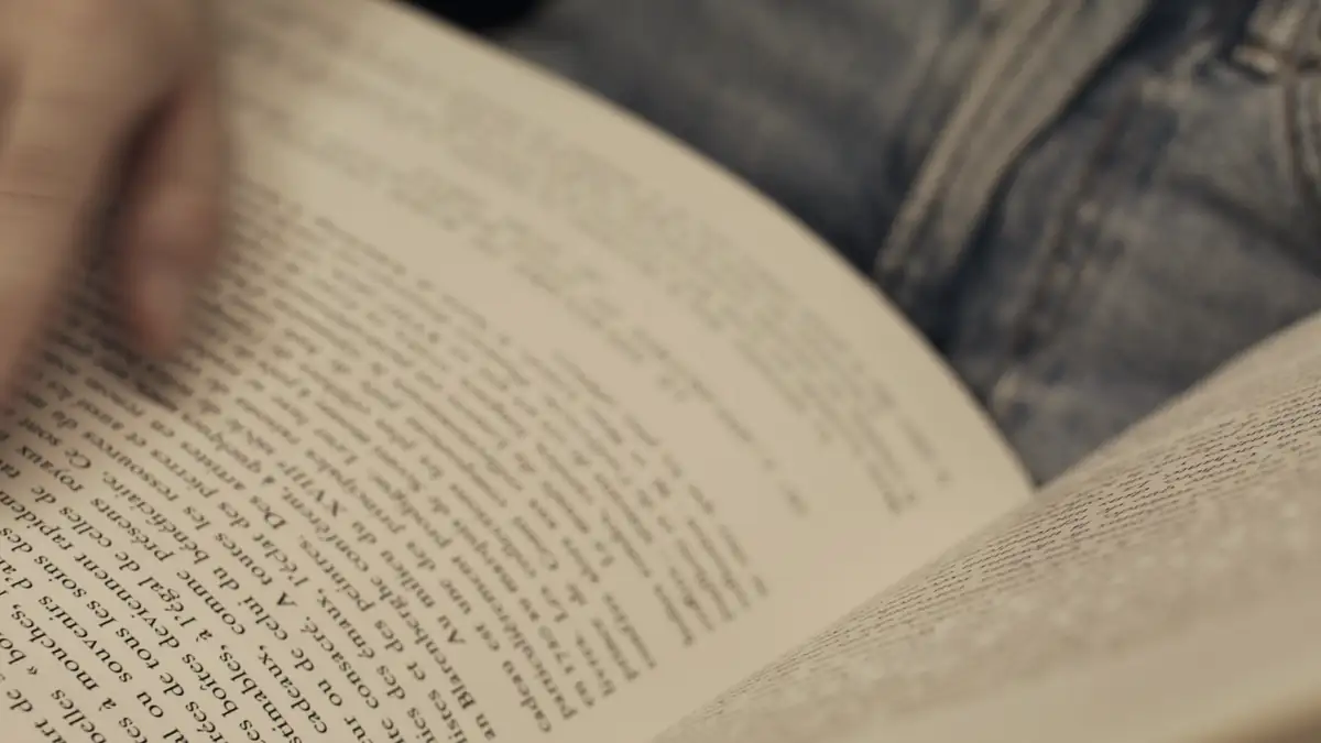 Hands turning the pages of a book